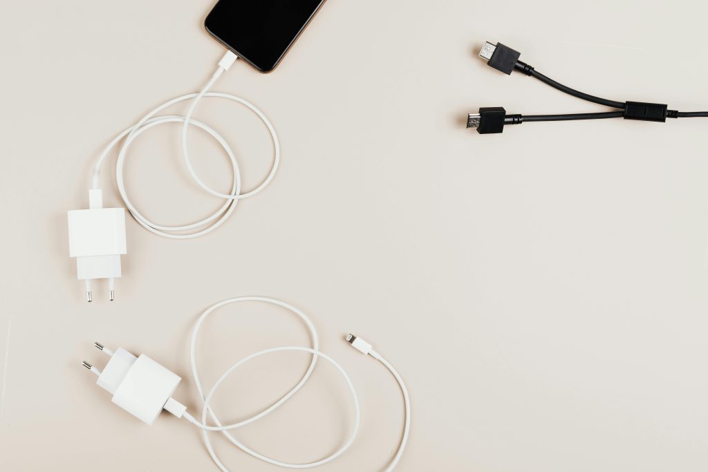 Counterfeit phone chargers with fake branding and poor-quality materials